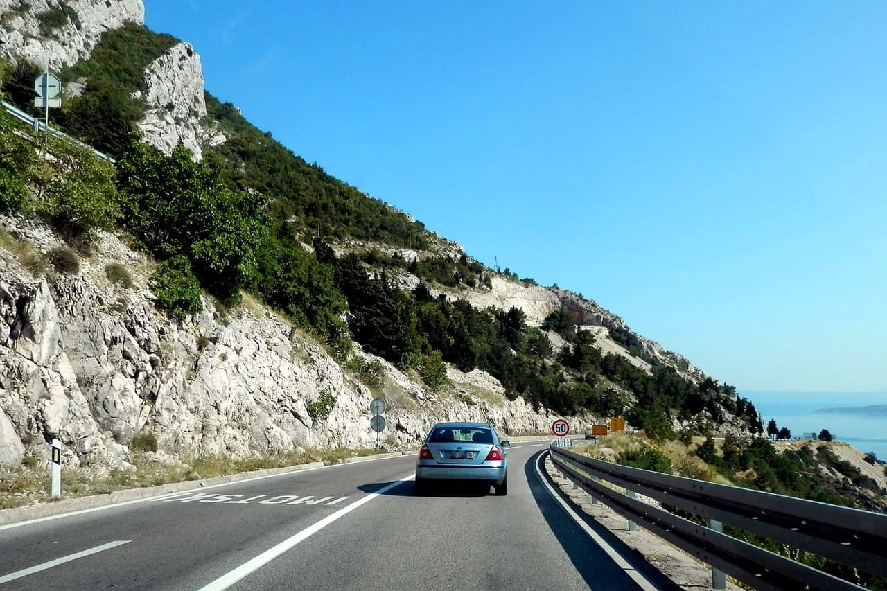 A car on the D8 coastal road between Omiš and Brela