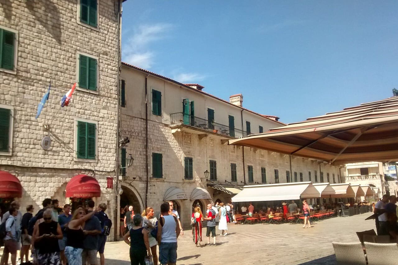 Café terraces on a square inside the walls of Kotor's Old Town