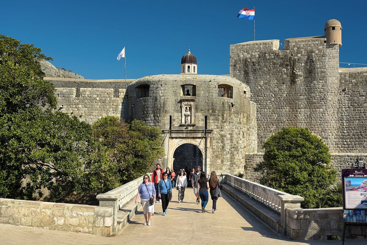 Visitors crossing the stone bridge to Pile Gate, the western entrance to Dubrovnik's Old Town